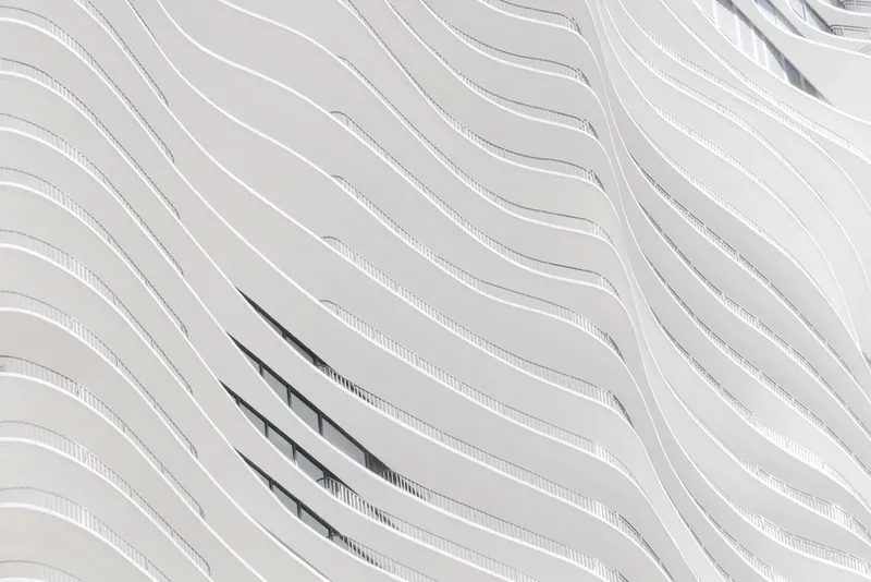 A white building facade with wave-shaped lines