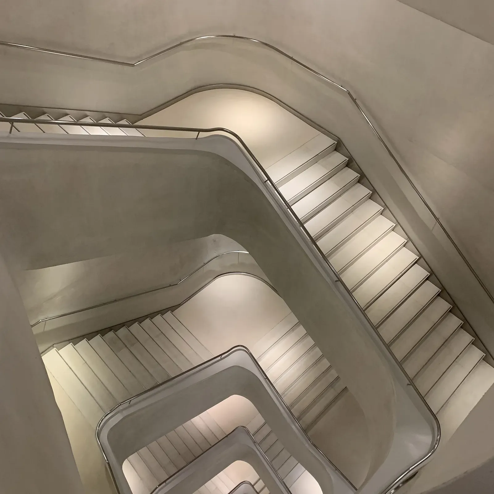 Looking down a white spiral staircase